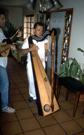 Jesus Rodriguez playing Venezuelan harp while an unidentified man plays the cuatro- Miami, Florida