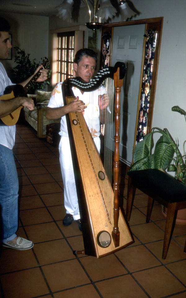 Jesus Rodriguez playing Venezuelan harp while an unidentified man plays the cuatro- Miami, Florida