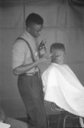 Vaughan McCall cutting and styling hair at the Zora Neale Hurston Festival- Eatonville, Florida.