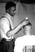 Vaughan McCall cutting and styling hair at the Zora Neale Hurston Festival- Eatonville, Florida