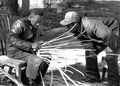 Apprentice Michael Steen watches Alphonso Jennings working on a white oak basket - Lamont, Florida