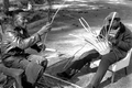 Apprentice Michael Steen (R) making a white oak basket as teacher Alphonso Jennings cuts white oak into strips - Lamont, Florida