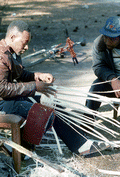 Apprentice Michael Steen (R) watches teacher Alphonso Jennings make a white oak basket - Lamont, Florida