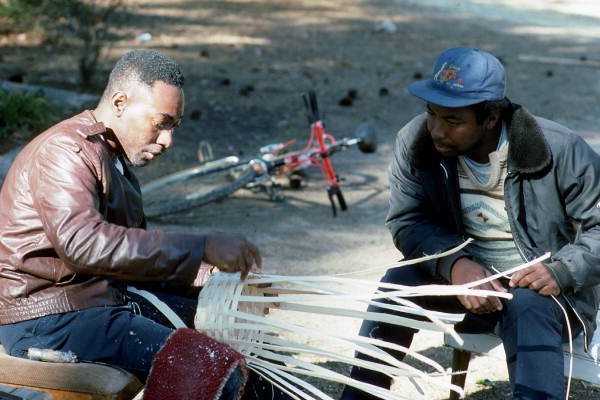 Apprentice Michael Steen (R) watches teacher Alphonso Jennings make a white oak basket - Lamont, Florida