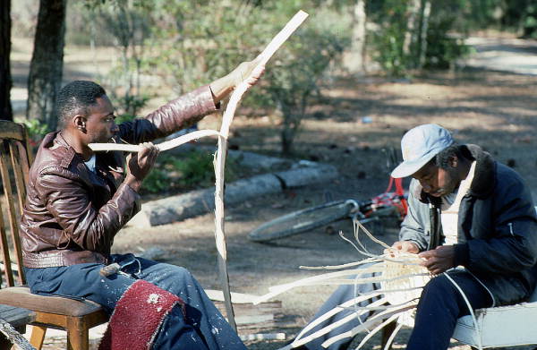 Apprentice Michael Steen (R) making a white oak basket as teacher Alphonso Jennings cuts white oak into strips - Lamont, Florida