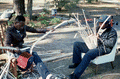 Apprentice Michael Steen (R) making a white oak basket as teacher Alphonso Jennings cuts white oak into strips - Lamont, Florida