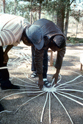 Apprentice Michael Steen (L) watches teacher Alphonso Jennings as he lays out the pattern of a white oak basket - Lamont, Florida