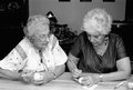 Ukrainian Easter egg decorator Ola Kryway (L) guides apprentice Mary Martin in applying wax to an egg - Titusville, Florida.
