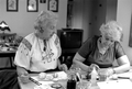 Ola Kryway (L) looks on as apprentice Mary Martin decorates Easter eggs with the Ukrainian pysanky technique - Titusville, Florida.