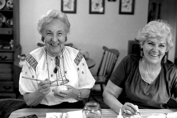 Ola Kryway (L) and apprentice Mary Martin decorating Easter eggs using the Ukrainian pysanky technique - Titusville, Florida.