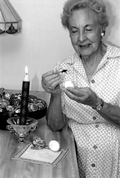 Ola Kryway decorating an Easter egg by applying melted beeswax with a kystka - Titusville, Florida.