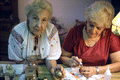 Ola Kryway (L) shows Easter egg as apprentice Mary Martin decorates another using the Ukrainian pysanky technique - Titusville, Florida.