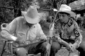 Cow whip maker George "Junior" Mills (l) braids a whip as his apprentice J. Taylor Marcus observes - Okeechobee, Florida.