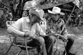 Cow whip maker George "Junior" Mills (l) works as his apprentice J. Taylor Marcus observes - Okeechobee, Florida.