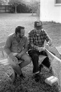 Apprentice Reginald Reis observes while master netmaker Max Dooley works on a net - Lakeland, Florida.