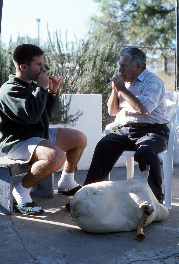 Tsabouna player Nikitas Tsimouris and his apprentice and grand-nephew Nikitas Kavouklis playing practice chanters. The tsabouna is in the foreground - Tarpon Springs, Florida