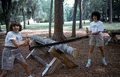 Debbie Fant, left, and Riki Saltzman sawing log at Fourth of July celebration - White Springs, Florida