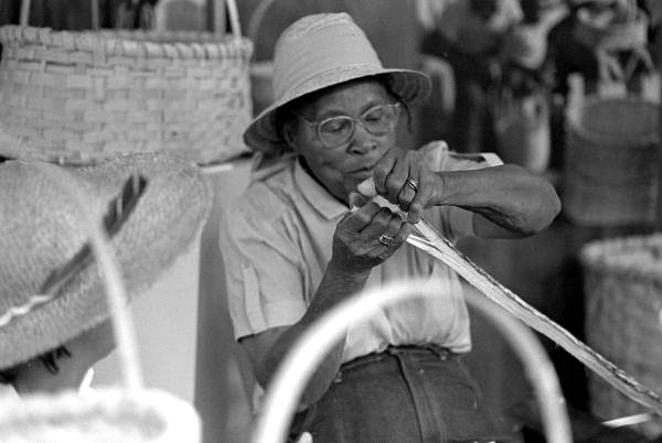 Basket maker Lucreaty Clark splitting white oak strips at the 1984 Florida Folk Festival - White Springs, Florida