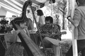 Jesus Rodriguez playing cuatro and his apprentice Ana Maria de Armas playing Venezuelan harp at the 1988 Florida Folk Festival - White Springs, Florida