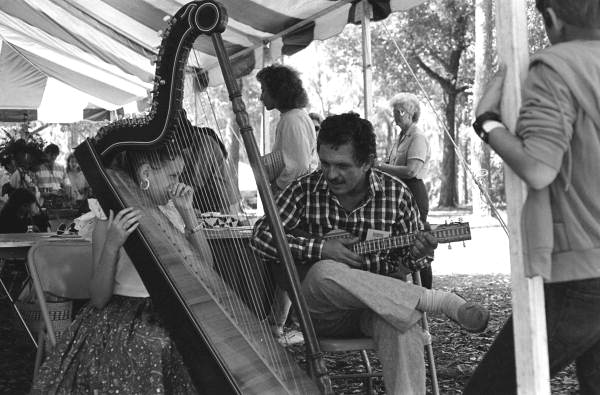 Jesus Rodriguez playing cuatro and his apprentice Ana Maria de Armas playing Venezuelan harp at the 1988 Florida Folk Festival - White Springs, Florida