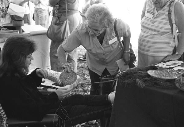 Basket maker demonstrating pine needle basketry techniques at the 1988 Florida Folk Festival - White Springs, Florida