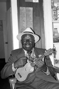 Portrait of William "Washboard Bill" Cooke with his ukulele