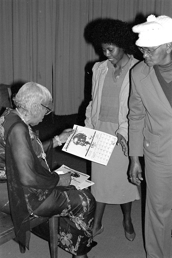 Mary McClain giving out calendars - Williston, Florida