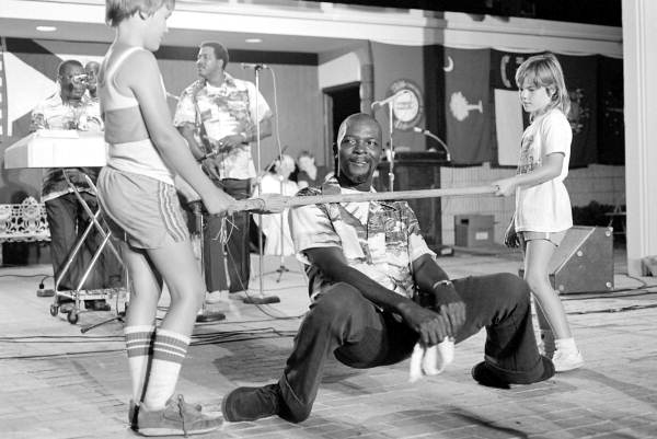 Member of the Key West Island Junkanoos limbo dancing at the 1983 Florida Folk Festival - White Springs, Florida