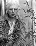 Mrs. Donnie Gader inspects the datil pepper plants growing in her backyard.