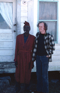 Diddley bow player Moses Williams with folklorist Dwight DeVane (?).