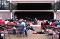 Jean Ritchie playing an autoharp while the crowd listens - White Springs, Florida