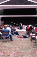 Jean Ritchie playing an autoharp while the crowd listens - White Springs, Florida