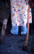 Basket maker Lucreaty Clark holding an axe and piece of white oak tree