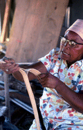 Basket maker Lucreaty Clark tearing white oak into strips