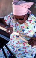 Basket maker Lucreaty Clark tearing white oak into strips