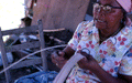 Basket maker Lucreaty Clark tearing white oak into strips