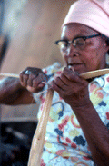 Basket maker Lucreaty Clark tearing white oak into strips