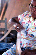 Basket maker Lucreaty Clark tearing white oak into strips