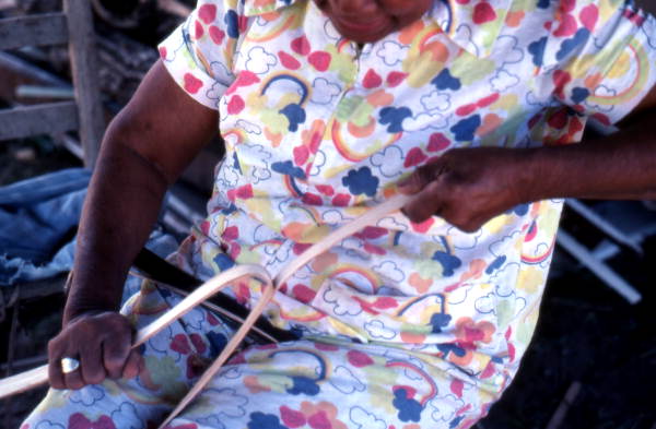 Basket maker Lucreaty Clark tearing white oak into strips