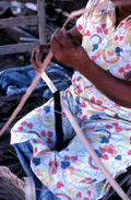 Basket maker Lucreaty Clark tearing white oak into strips