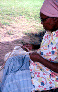 Basket maker Lucreaty Clark cutting white oak into strips