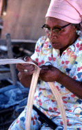 Basket maker Lucreaty Clark cutting white oak into strips