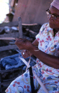 Basket maker Lucreaty Clark cutting white oak into strips