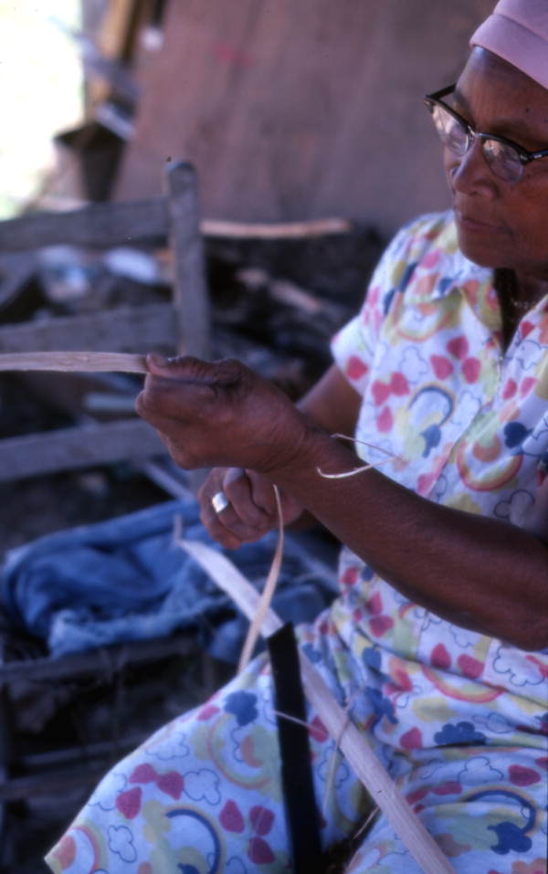 Basket maker Lucreaty Clark cutting white oak into strips