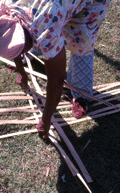 Basket maker Lucreaty Clark laying out strips of white oak