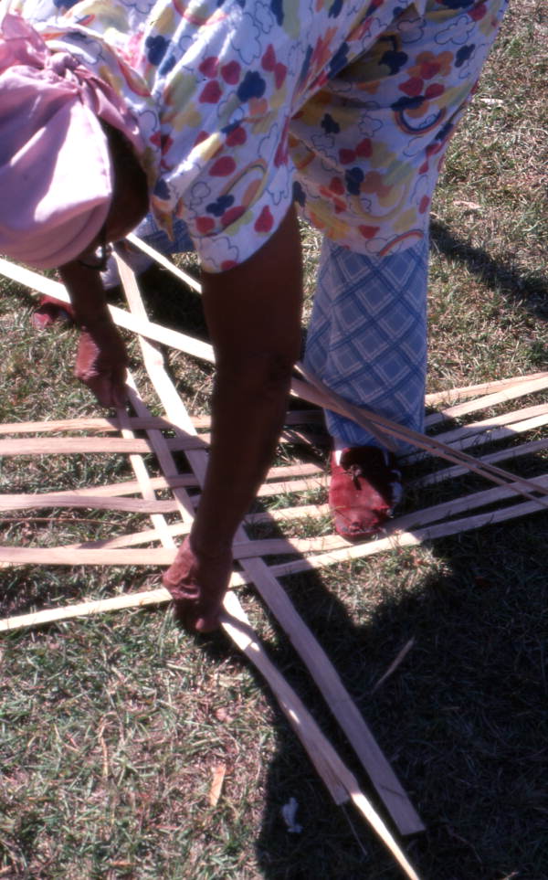 Basket maker Lucreaty Clark laying out strips of white oak