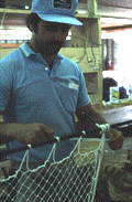 Billy Burbank III in the process of making a fishing net - Fernandina Beach, Florida