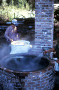 Adding water to the sugar cane juice - Orlando, Florida.