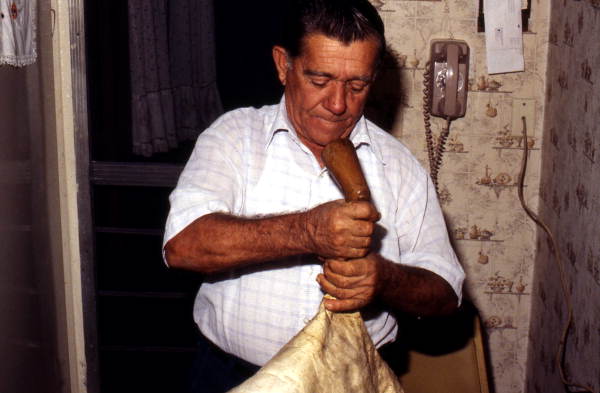 Nikitas Tsimouris preparing to play a tsambouna - Tarpon Springs, Florida