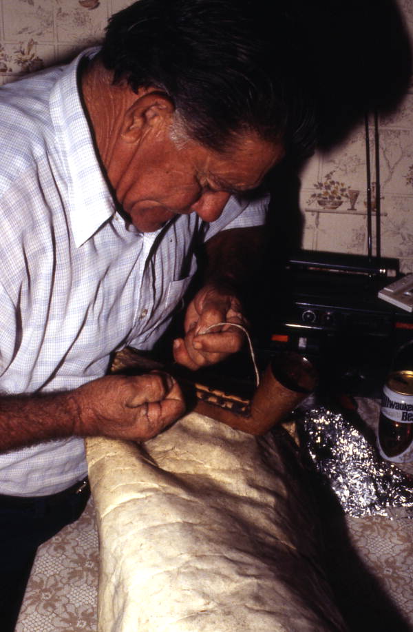 Nikitas Tsimouris preparing to play a tsambouna - Tarpon Springs, Florida